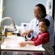 child-is-taught-to-wash-hands-at-kitchen-sink-725x483